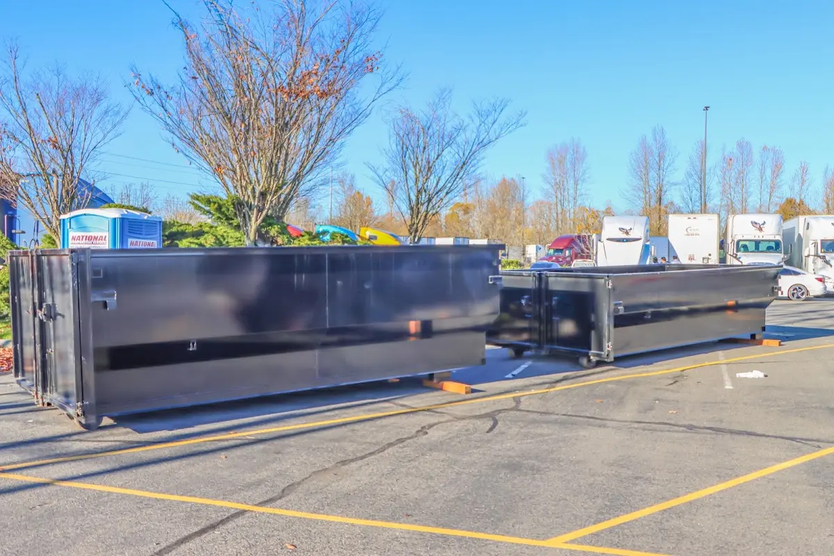 Professional dumpster rental service with roll-off container on residential driveway in Raleigh